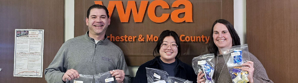 Kinecta employees stand for a picture in front of the YWCA in Rochester, New York.
