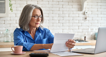 mature women looking over her retirement documents
