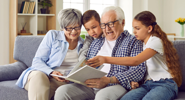 grandparents on a couch with their grandchildren