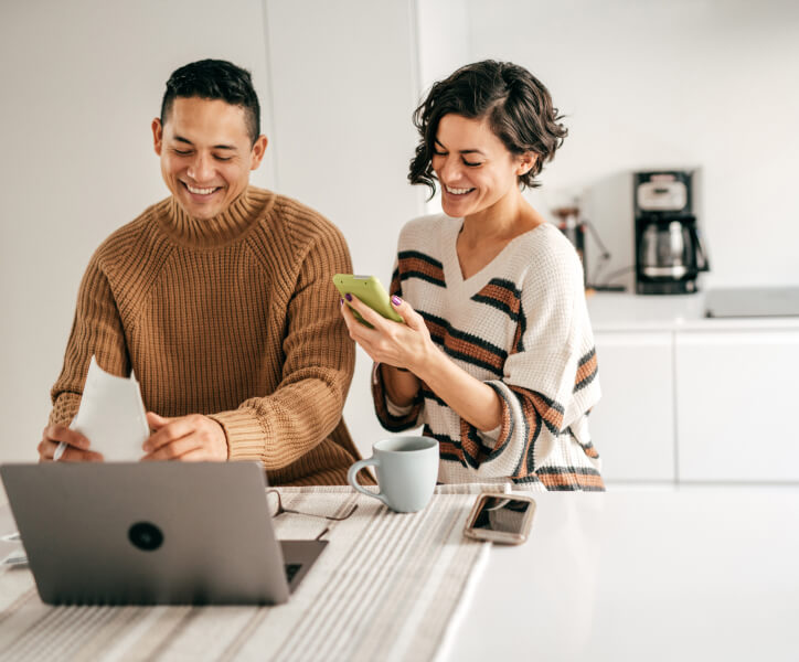 Couple looking over online banking on devices