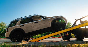 image of a vehicle being loaded on a tow truck
