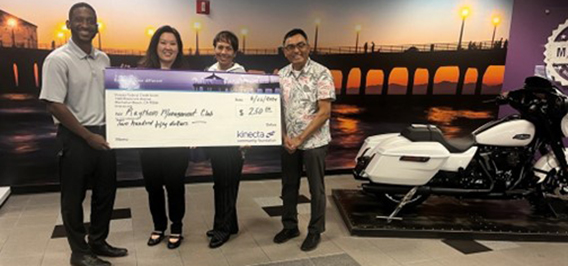 image of raytheon management club check presentation