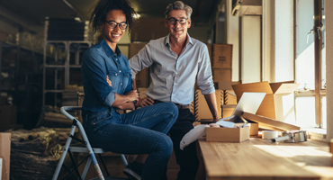 couple business owners looking at the camera